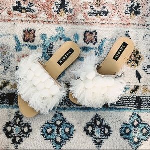 White fringe and pompom sandals